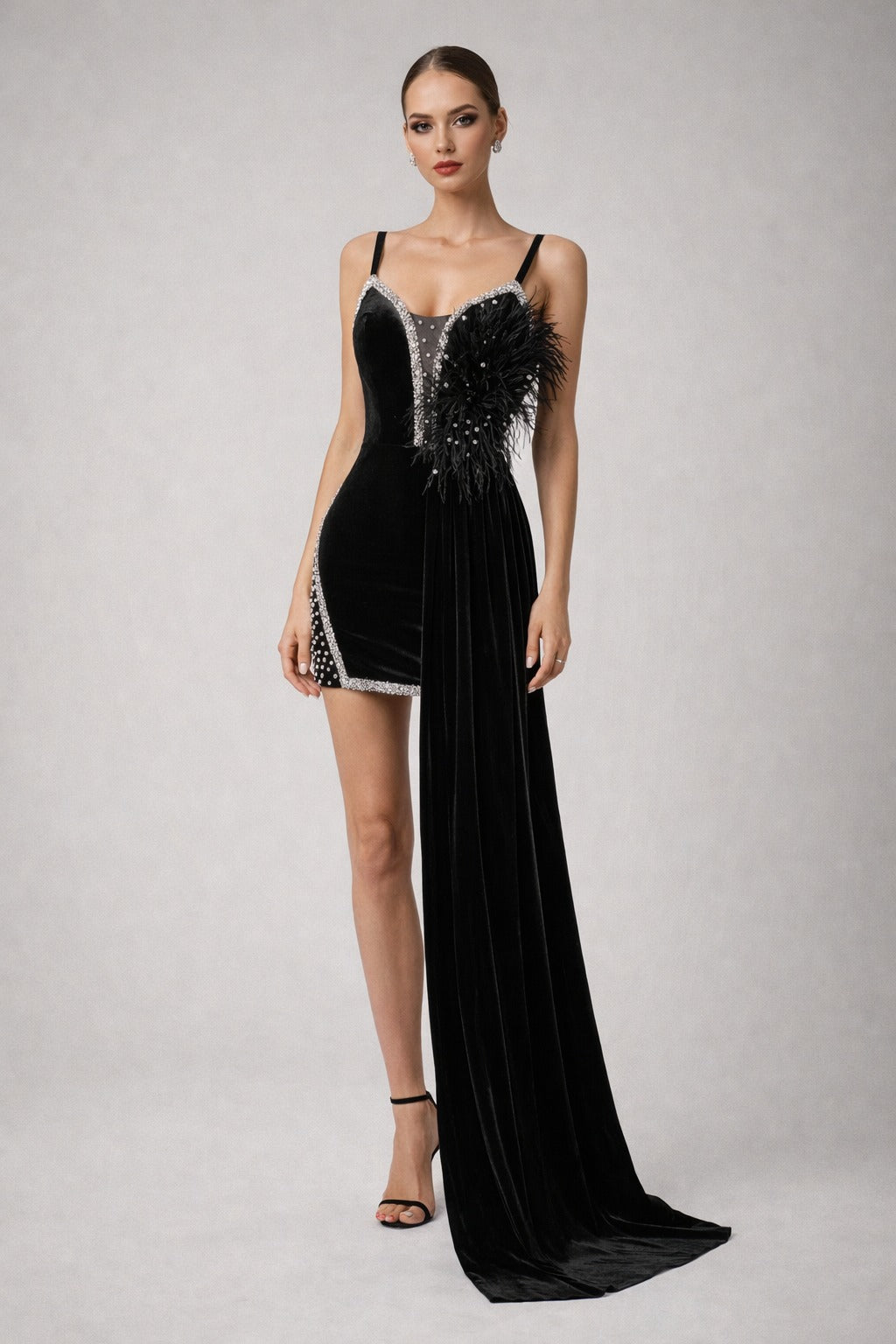 A glamorous black velvet mini dress with a fitted silhouette